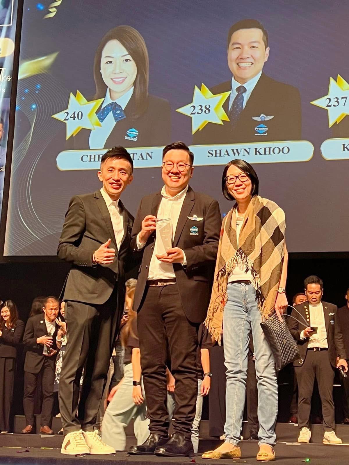 Shawn Khoo on stage at a PropNex award ceremony